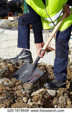 Construction worker with a shovel, Building hand tool, Donostia, San Sebastian, Gipuzkoa, Basque Country, Spain View Large Photo Image Stock Photo - Construction worker with a shovel, Building hand tool, Donostia, San Sebastian, Gipuzkoa, Basque Country, Spain. Fotosearch