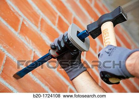 Construction worker with pot and chisel, making chases in brick wall, Hand tools for construction, House Construction, Basque Country, Spain View Large Photo Image Stock Photo - Construction worker with pot and chisel, making chases in brick wall, Hand tools for construction, House Construction, Basque Country, Spain. Fotosearch