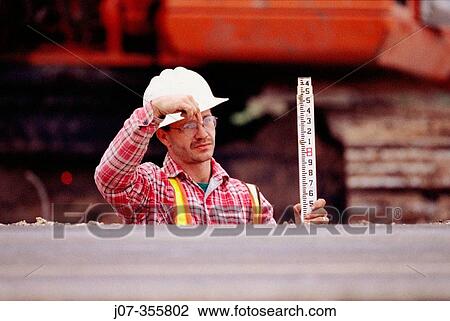 Construction worker with survey staff. Texas. USA. View Large Photo Image Stock Image - Construction worker with survey staff. Texas. USA.. Fotosearch