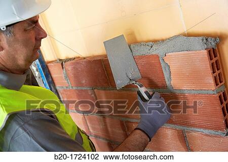Construction worker with trowel, hand tools, Placement of brick with mortar on interior walls of housing, House Construction, Basque Country, Spain View Large Photo Image Stock Image - Construction worker with trowel, hand tools, Placement of brick with mortar on interior walls of housing, House Construction, Basque Country, Spain. Fotosearch