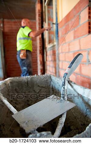 Construction worker with trowel, hand tools, Placement of brick with mortar on interior walls of housing, House Construction, Basque Country, Spain View Large Photo Image Stock Image - Construction worker with trowel, hand tools, Placement of brick with mortar on interior walls of housing, House Construction, Basque Country, Spain. Fotosearch