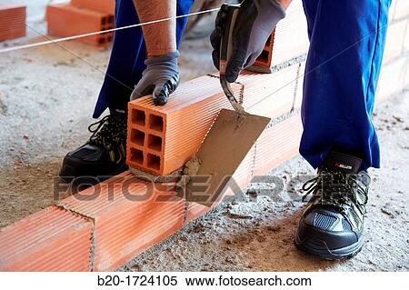Construction worker with trowel, hand tools, Placement of brick with mortar on interior walls of housing, House Construction, Basque Country, Spain View Large Photo Image Stock Photography - Construction worker with trowel, hand tools, Placement of brick with mortar on interior walls of housing, House Construction, Basque Country, Spain. Fotosearch