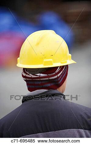 Construction worker with yellow hard hat from behind View Large Photo Image Stock Photography - Construction worker with yellow hard hat from behind. Fotosearch