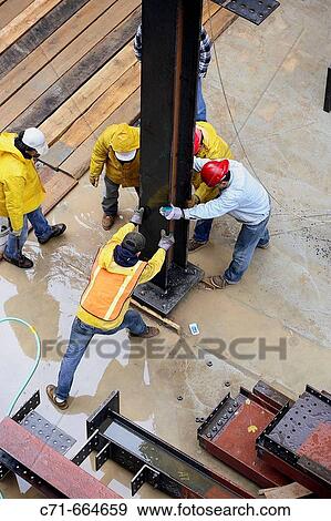 Construction workers erecting steel I beam View Large Photo Image Stock Photo - Construction workers erecting steel I beam. Fotosearch