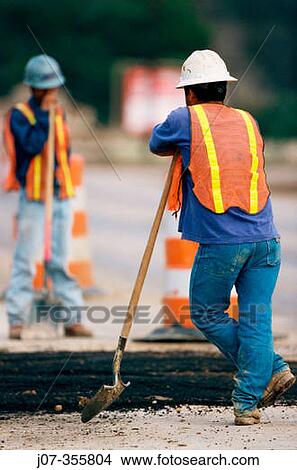 Construction workers leaning on shovels. Texas. USA. View Large Photo Image Picture - Construction workers leaning on shovels. Texas. USA.. Fotosearch