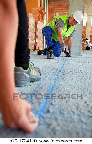 Construction workers marking guides for building interior walls of a house, House Construction, Basque Country, Spain View Large Photo Image Stock Image - Construction workers marking guides for building interior walls of a house, House Construction, Basque Country, Spain. Fotosearch
