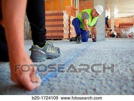 Construction workers marking guides for building interior walls of a house, House Construction, Basque Country, Spain View Large Photo Image Stock Photo - Construction workers marking guides for building interior walls of a house, House Construction, Basque Country, Spain. Fotosearch