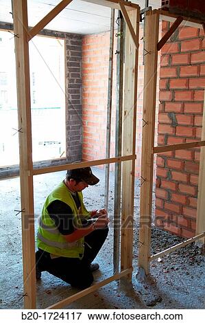 Construction workers marking guides for building interior walls of a house, Housing Construction, Basque Country, Spain View Large Photo Image Stock Photo - Construction workers marking guides for building interior walls of a house, Housing Construction, Basque Country, Spain. Fotosearch