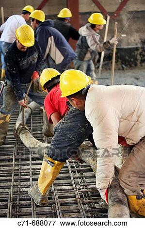 Construction workers with concrete pumper hose pouring concrete floor View Large Photo Image Stock Photo - Construction workers with concrete pumper hose pouring concrete floor. Fotosearch