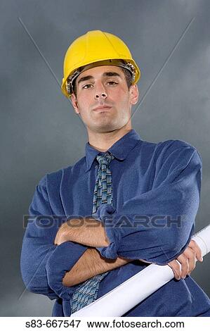 Stock Photo - Constuction foreman holding plans. Fotosearch