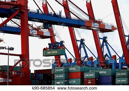 Container are offloaded by bridge like cranes from cargo ships in Hamburg harbor, Germany, Europe View Large Photo Image Picture - Container are offloaded by bridge like cranes from cargo ships in Hamburg harbor, Germany, Europe. Fotosearch