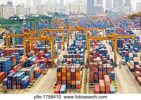 Stock Image - Containers stacked together at the Port of Singapore Authority PSA in Singapore PSA Singapore Terminals is the world largest container transhipment hub, handling about one-fifth of the world's total container transhipment throughput. Fotosearch