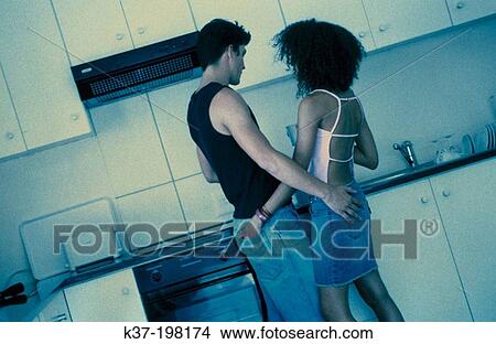 Contemporary couple in Kitchen View Large Photo Image Picture - Contemporary couple in Kitchen. Fotosearch