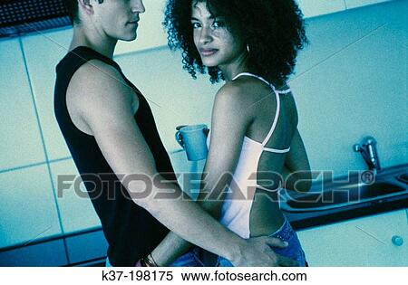Stock Photography - Contemporary couple in Kitchen. Fotosearch