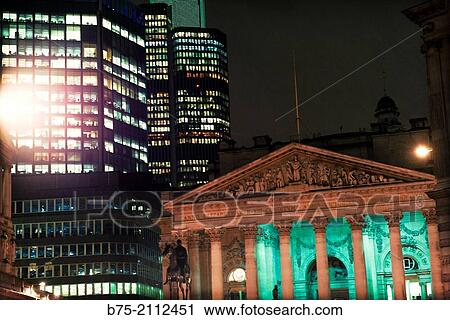 Contrast of modern and ancient buildings. The old Stock Exchange building iluminated at night. City of London, England, UK, Europe. View Large Photo Image Stock Image - Contrast of modern and ancient buildings. The old Stock Exchange building iluminated at night. City of London, England, UK, Europe.. Fotosearch