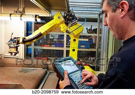 Stock Photo - Control panel. Robot with vision. Loading transfer machine machining. Machined Indecober. Machining of precision parts in series. Automotive industry. Berriz. Bizkaia. Basque Country. Spain.. Fotosearch
