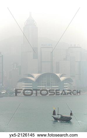 Stock Photography - Convention Centre and Victoria harbour in the morning fog, Hong Kong.. Fotosearch