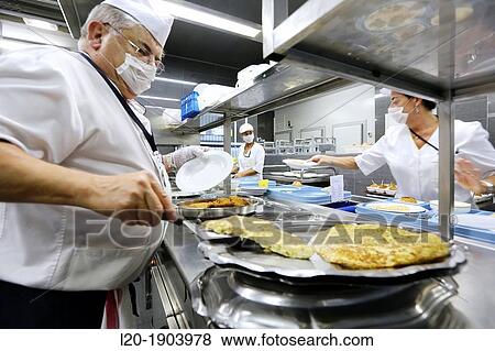 Stock Photo - Cook, Food menu preparation, hospital kitchen, Onkologikoa Hospital, Oncology Institute, Case Center for prevention, diagnosis and treatment of cancer, Donostia, San Sebastian, Gipuzkoa, Basque Country, Spain. Fotosearch