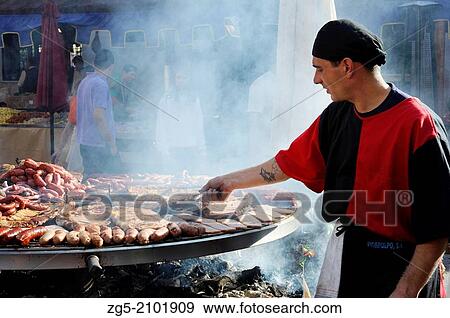 cook handles giant barbecue in the annual All Saints Market in Concentaina, Alicante province, Spain. View Large Photo Image Stock Photo - cook handles giant barbecue in the annual All Saints Market in Concentaina, Alicante province, Spain.. Fotosearch