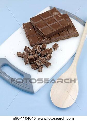Cooking chocolate chopped on a cutting board isolated against a blue background View Large Photo Image Stock Photography - Cooking chocolate chopped on a cutting board isolated against a blue background. Fotosearch