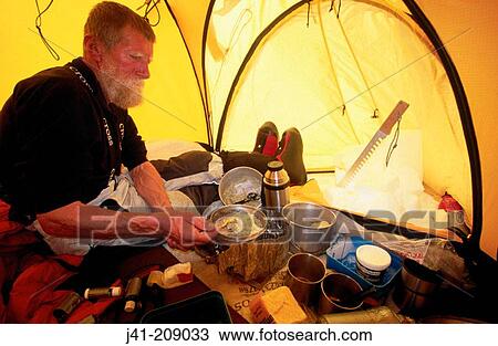 Stock Image - Cooking inside tent. Denali National Park. Alaska. USA. Fotosearch