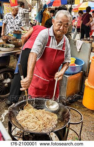 cooking stir fried noodles in a wok in Penang, Malaysia. View Large Photo Image Stock Image - cooking stir fried noodles in a wok in Penang, Malaysia.. Fotosearch