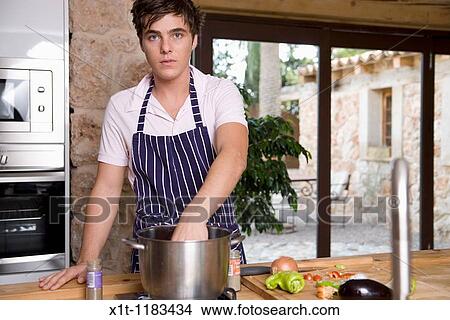 cooking young man. View Large Photo Image Picture - cooking young man.. Fotosearch
