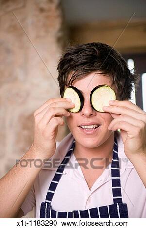 Stock Image - Cooking young man.. Fotosearch