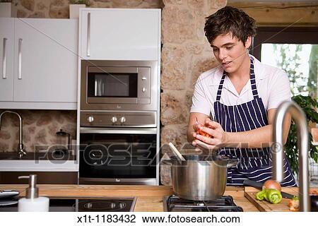Stock Image - cooking young man.. Fotosearch