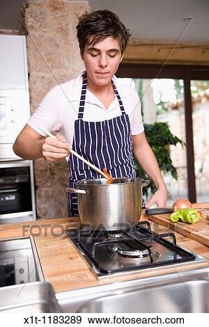 Cooking young man. View Large Photo Image Stock Photo - Cooking young man.. Fotosearch