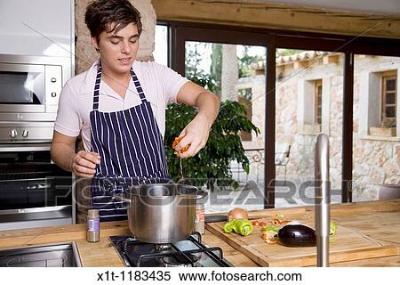 Cooking young man. View Large Photo Image Stock Photography - Cooking young man.. Fotosearch