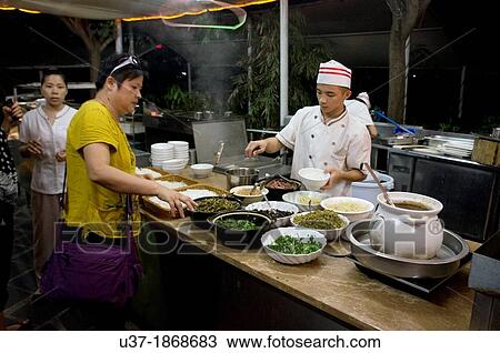 Stock Image - Cooks at Lageur Resort Sanya Beach, Hainan Island.. Fotosearch