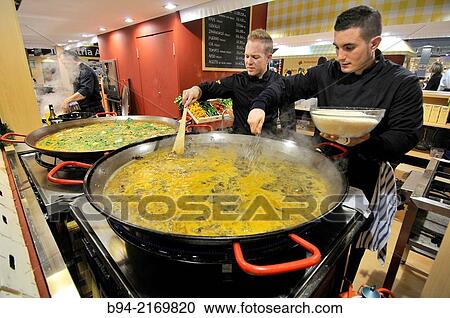Cooks making a paella in Alimentaria, International Food and Drinks Exhibition, Fira de Barcelona. L? Hospitalet de Llobregat, Barcelona, Catalonia, Spain. View Large Photo Image Stock Image - Cooks making a paella in Alimentaria, International Food and Drinks Exhibition, Fira de Barcelona. L? Hospitalet de Llobregat, Barcelona, Catalonia, Spain.. Fotosearch