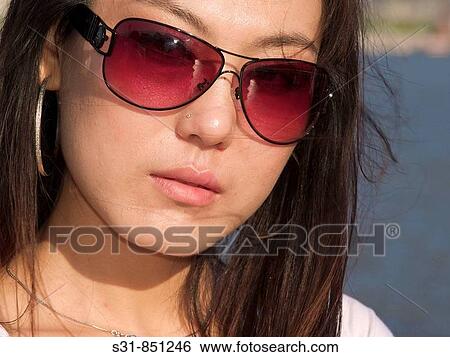 Stock Photograph - Cool asian girl wearing sunglasses. Fotosearch