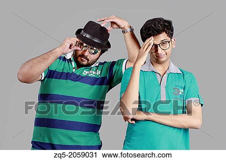 Stock Image - Cool dudes, Bearded guy wearing sunglasses, bored boy.. Fotosearch