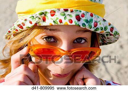 Stock Photography - Cool girl wearing colourful hat, 13 year old. Fotosearch