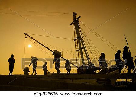 Stock Photograph - Coolies carrying cement in Sunda Kelapa Harbour, Jakarta, Indonesia. Fotosearch