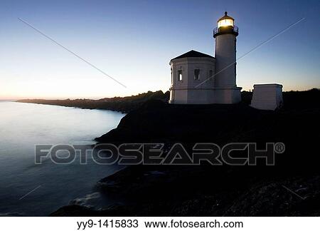 Stock Image - Coquille River Lighthouse at nightfall - Bullard's Beach State Park - Bandon, Oregon. Fotosearch