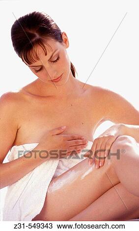 Stock Image - Cora, Towel, Sitting, Cream Applying. Fotosearch