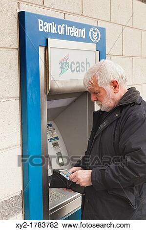 Cork, County Cork, Ireland Elderly man withdrawing money from Bank of Ireland cash dispenser View Large Photo Image Stock Image - Cork, County Cork, Ireland Elderly man withdrawing money from Bank of Ireland cash dispenser. Fotosearch