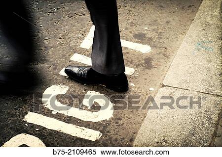 Corporate executive unrecognizable crossing a street, stepping right word, written in the asphalt. London, England, UK, Europe. View Large Photo Image Stock Photography - Corporate executive unrecognizable crossing a street, stepping right word, written in the asphalt. London, England, UK, Europe.. Fotosearch