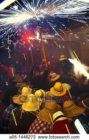 Stock Image - ? Correfoc? Catalan traditional festival 16th August where people dressed as devils light fireworks while dancing in the street, La Bisbal d? Emporda, Baix Emporda, Costa Brava, Girona province, Catalonia, Spain. Fotosearch