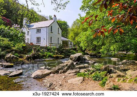 Cottage beside the East Lyn River at Rockford in Exmoor during spring near Lynmouth, Devon, England View Large Photo Image Picture - Cottage beside the East Lyn River at Rockford in Exmoor during spring near Lynmouth, Devon, England. Fotosearch