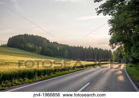 Country Road Passes Wheat Field at Sunset near Bad Schallerbach, Upper Austria, Austria. View Large Photo Image Stock Photograph - Country Road Passes Wheat Field at Sunset near Bad Schallerbach, Upper Austria, Austria.. Fotosearch