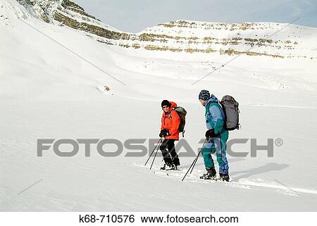 Couple, 60, back country skiing in Banff National Park, Alberta, Canada near Dolomite peak View Large Photo Image Stock Photograph - Couple, 60, back country skiing in Banff National Park, Alberta, Canada near Dolomite peak. Fotosearch