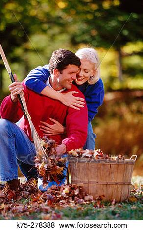 Stock Photo - Couple and basket of leaves. Fotosearch