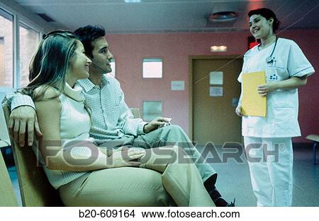 Couple and nurse at waiting area of hospital View Large Photo Image Picture - Couple and nurse at waiting area of hospital. Fotosearch