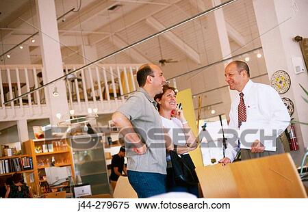 Couple and salesman talking in a furniture store View Large Photo Image Stock Photography - Couple and salesman talking in a furniture store. Fotosearch