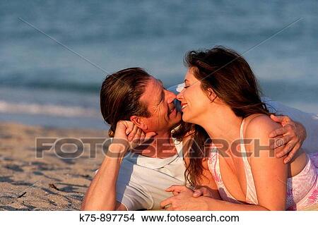 Couple at beach View Large Photo Image Picture - Couple at beach. Fotosearch