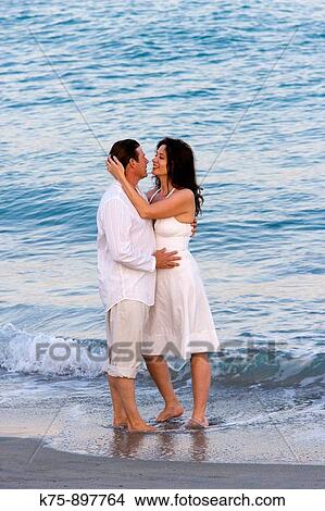 Couple at beach View Large Photo Image Picture - Couple at beach. Fotosearch